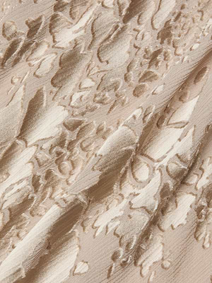 Close-up of the Christine Burnout Satin Gown’s beige fabric, showcasing a raised floral pattern with a soft sheen and diagonal folds that evoke an elegant, bias-cut silhouette.