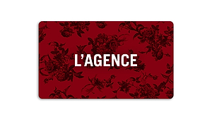 The L'AGENCE Gift Card features a deep red rectangular design with black floral patterns and bold white L'AGENCE lettering, delivered by email with easy-to-follow redemption instructions.