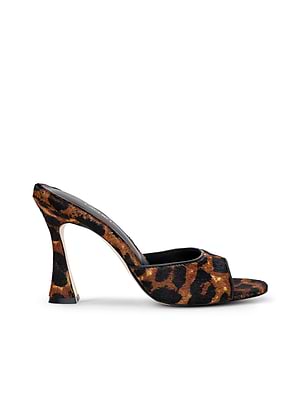 The Avery Open-Toe Mule features a sculpted stiletto with a curved heel and open toe, showcasing a bold brown and black leopard hair calf upper and wide strap for a sleek, elegant finish.